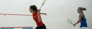 AJN Steelstock, steel stockholders, Emma Bartley about to hit a ball to serve against an opponent in squash