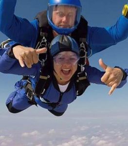 An AJN employee enjoying themselves skydiving