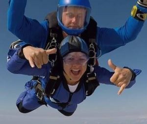 An AJN employee enjoying themselves skydiving